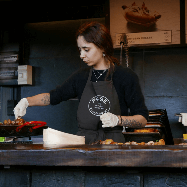 A female сhef frying on the grill