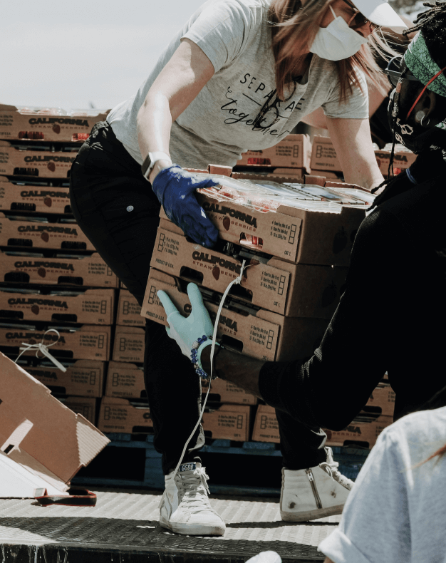 A woman unloading the truck of boxes