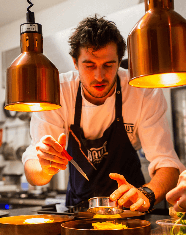 A chef putting the baked goods out of the molds